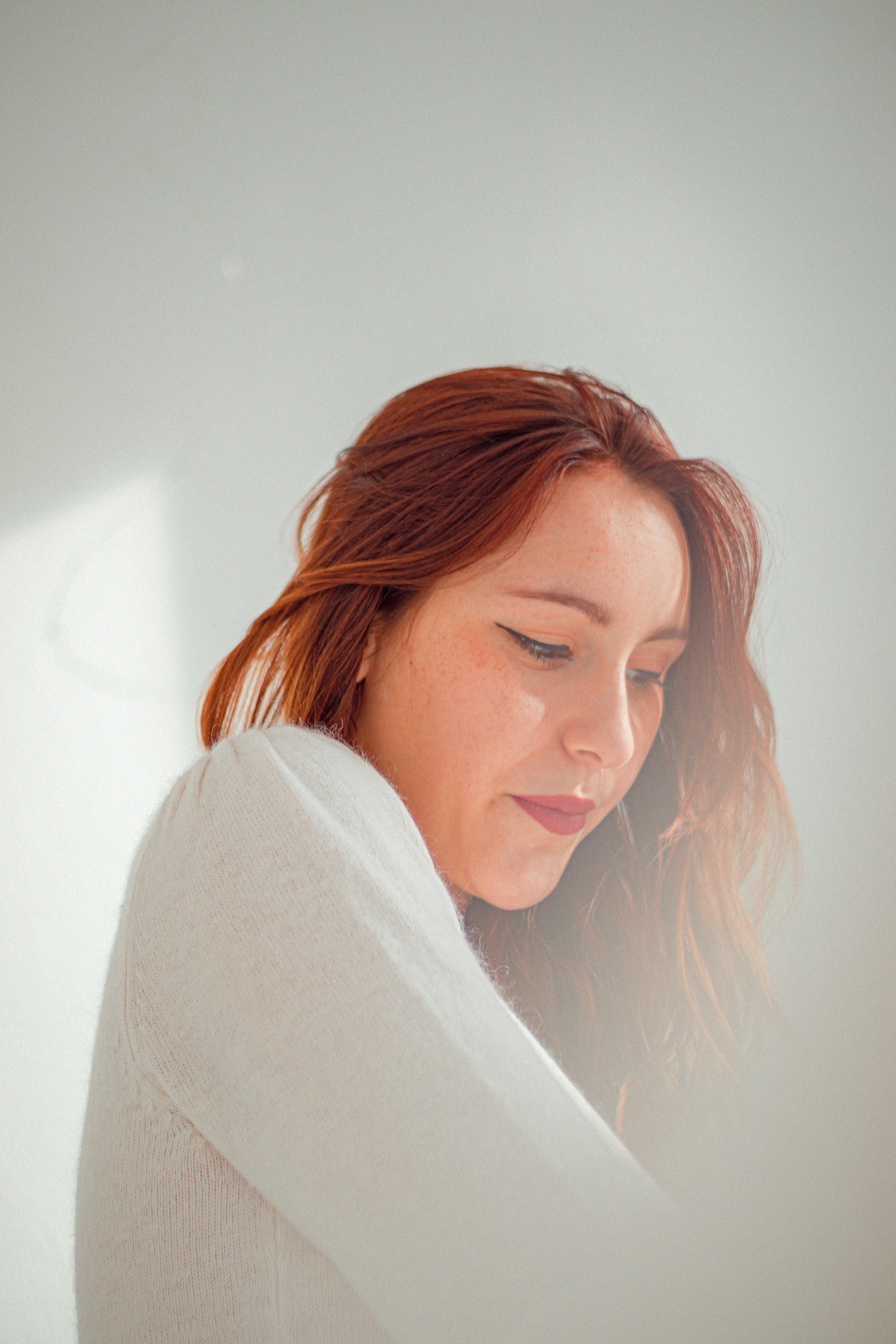 woman in white long sleeve shirt smiling